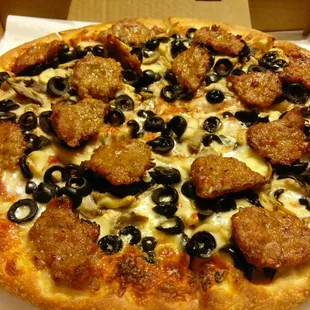 Large sausage, mushroom, black olive pizza