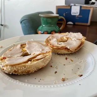 a half eaten bagel on a plate