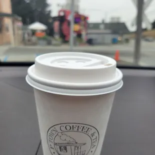 a coffee cup on the dashboard of a car