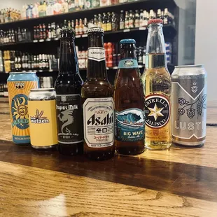 a variety of beers on a bar