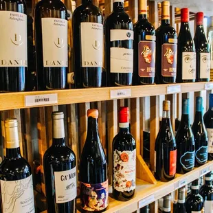 a shelf of wine bottles