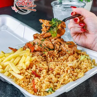  hand holding a fork over a plate of food