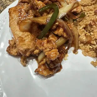 Close up of the pepper chicken on a plate at home. Sauce was wonderful and chicken super tender. Green peppers and onions done just right.