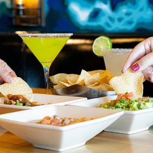 two hands grabbing a tortilla