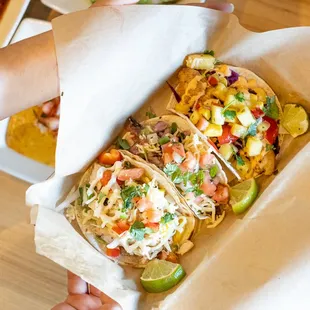 a person holding a taco