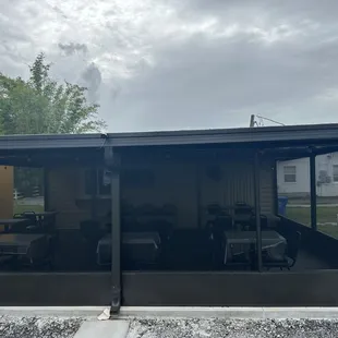 a view of a patio with tables and chairs