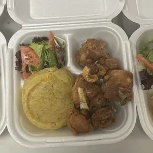 a variety of food items in a styrofoam container