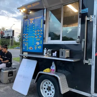 a food truck with a menu on the side