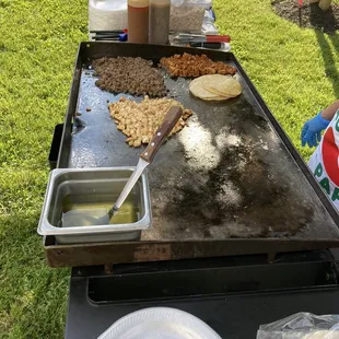 Tacos being prepared in a backyard.