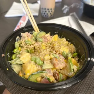 a bowl of food with chopsticks