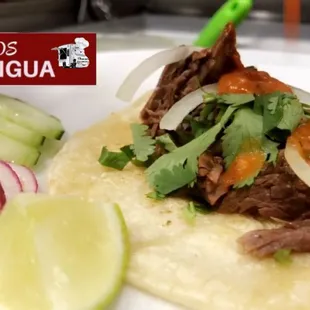 Authentic Mexican tongue(lengua) Tacos with cilantro onion fresh lemon and salsa roja on the side