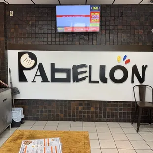 a coffee shop with a television in the background