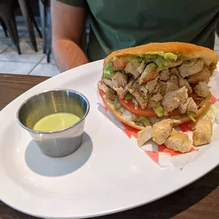 Pabellon arepa - chicken, tomato, lettuce, guac. Delicious cilantro sauce.