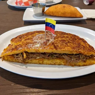 Cachapa - order this!!! Fried corn cake that is crispy and butter on the outside and soft on the inside. Split this.