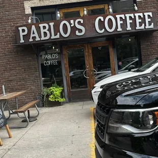 a car parked in front of a coffee shop
