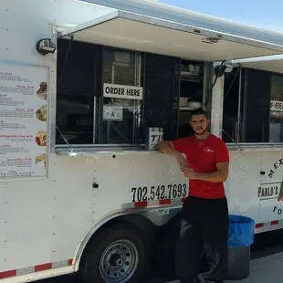 a man standing in front of a food truck
