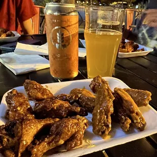 a plate of wings and a glass of beer
