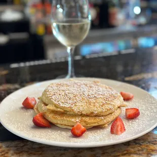a plate of pancakes and strawberries