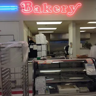 a bakery with a neon sign