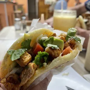 a person holding a taco