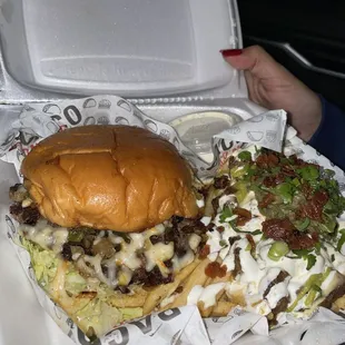 a person holding a tray of food