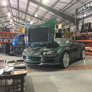 View from one of two couches overlooking one of the businesses show cars.