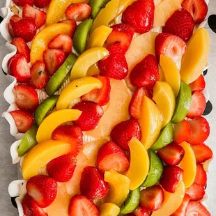 a fresh fruit platter on a polka dot tablecloth