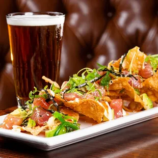 a plate of nachos and a glass of beer