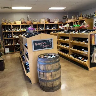 a display of wine bottles and barrels