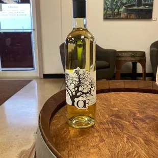 a bottle of wine on a barrel