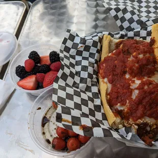 Meatball sandwich, fruit and caprese salad