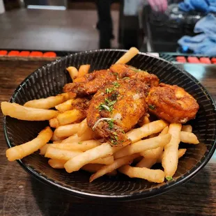 a bowl of fried chicken and french fries