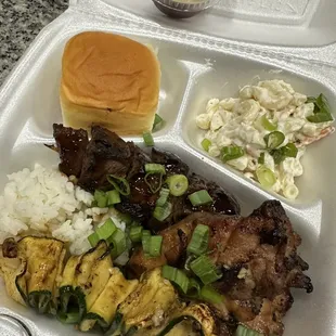 Plate with rice, shoyu chicken, beef teriyaki and grilled zucchini