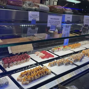 a display of sushi and rolls