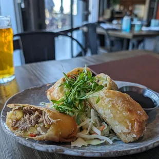 Duck spring rolls with hoisin sauce and garnish