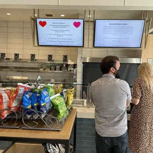 two people standing in front of a counter
