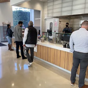 a group of people standing at a counter