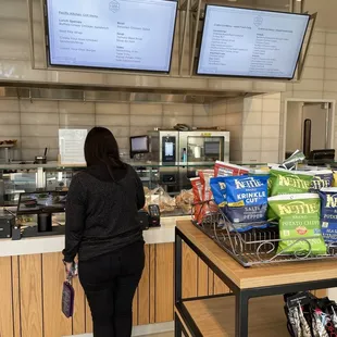 a woman standing in front of a counter