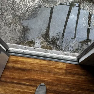 Another view of the puddle forming outside the door from the flood.