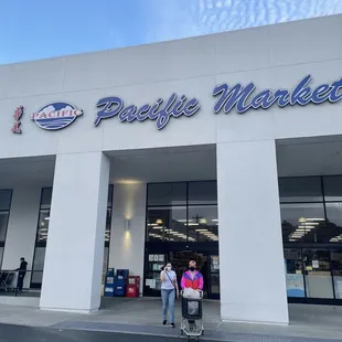 two people standing in front of the store
