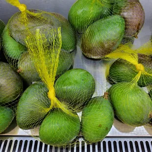 avocados wrapped in netting