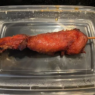 BBQ chicken on a stick. Portion of four and they're delicious - basically a deboned chicken wing.