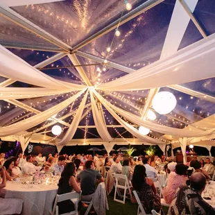 Stunning cafe lights, lanterns and white draping in a wheel formation under a clear top tent!