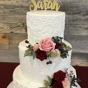 Wedding cake with custom cake topper and flowers