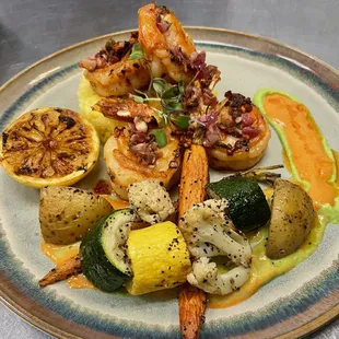 Grilled jumbo prawns paired with saffron rice and grilled veggies. Side of roasted bell pepper and peas puree