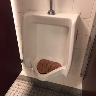 a urinal in a public restroom