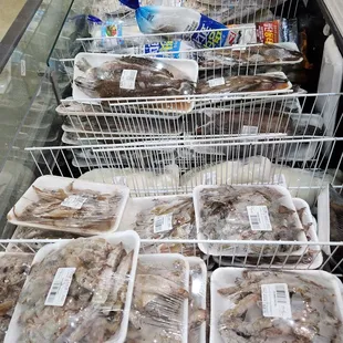 a display of shrimp in plastic containers