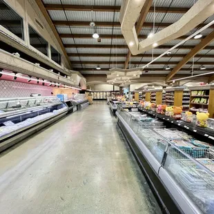 a grocery store with rows of frozen food