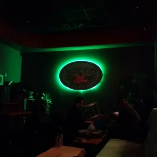 a green neon sign in a dark room