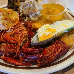 a plate of lobsters, eggs, and other foods
